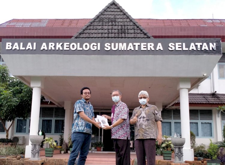 Pembina Yayasan Budhakirti Palembang Darwis Hidayat menyerahkan buku “Borobudur Biara Himpunan Kebajikan Sugata” kepada staf Balai Arkeologi Sumsel. (Dudy Oskandar/rmolsumsel.id)