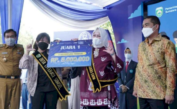 Duta Literasi Sumsel Ratu Tenny Leriva secara simbolis menyerahkan penghargaan stan terbaik kepada Bunda Literasi Kabupaten Muara Enim Renny Devi, Senin (8/11). (Dinas Kominfo Muara Enim/rmolsumsel.id) 