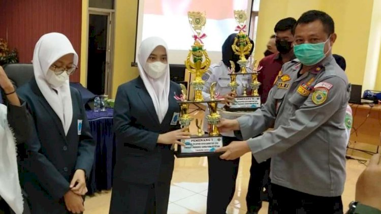 Siswi MAN Insan Cendekia Silma Nuraini menerima trofi juara Pemilihan Pelajar Pelopor Keselamatan LLAJ Tingkat Provinsi Sumsel, Selasa (28/12). (Dinas Kominfo OKI/rmolsumsel.id)