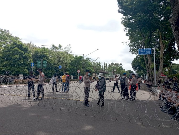 Pihak keamanan memasang kawat berduri di Jalan POM IX untuk menahan pengunjuk rasa agar tidak masuk ke Gedung DPRD Sumsel. (Mita Rosnita/RMOLSumsel.id). 