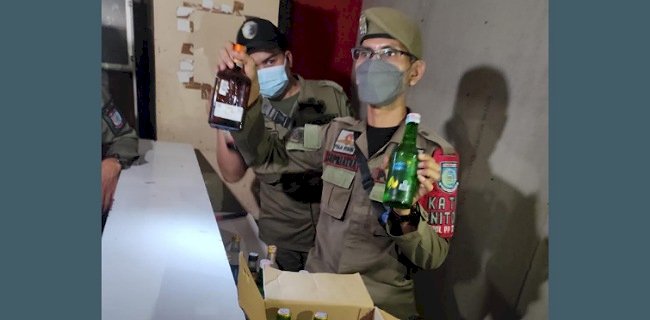 Satpol PP menunjukan miras hasil razia tempat hiburan yang masih buka saat bulan Ramadan. (ist/rmolsumsel.id)