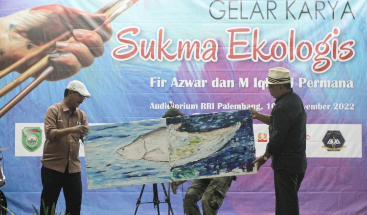 Dua pelukis Palembang, Fir Azwar (kiri) dan Iqbal J Permana (kanan) saat memamerkan hasil lukisan kolaborasinya saat pagelaran seni rupa Sukma Ekologis.  (adam/rmolsumsel.id)