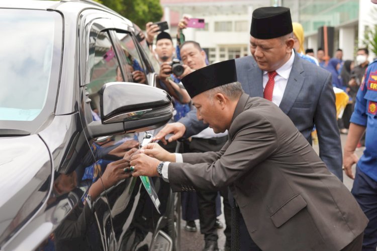 Pj Bupati Muba Apriyadi didampingi Pj Sekda Muba Musni Wijaya melakukan penempelan stiker di kendaraan dinas. (Ist/Dok). 